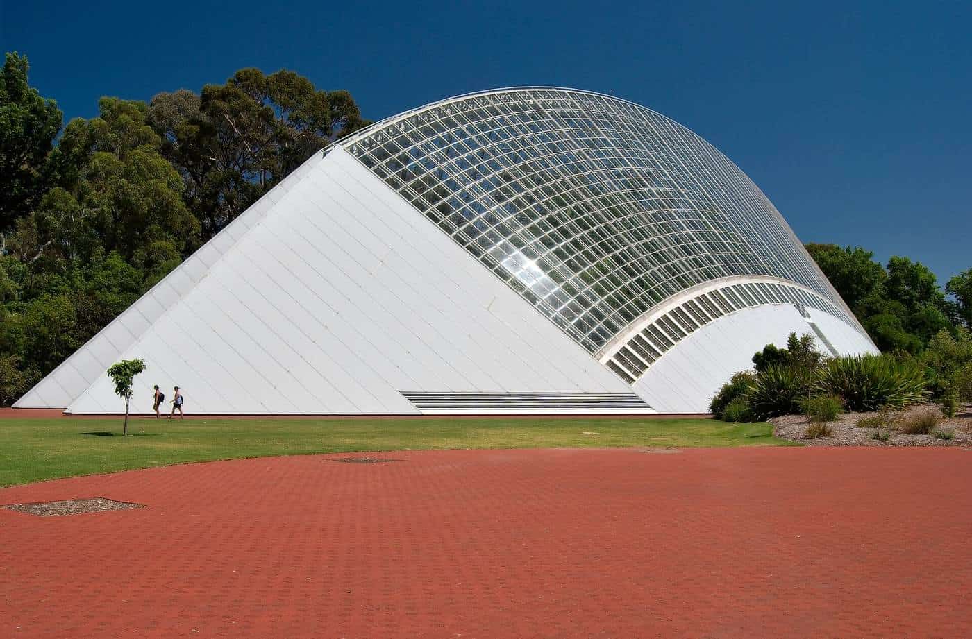 The Bicentennial Conservatory glasshouse in Adelaide Botanic Garden under a blue sky