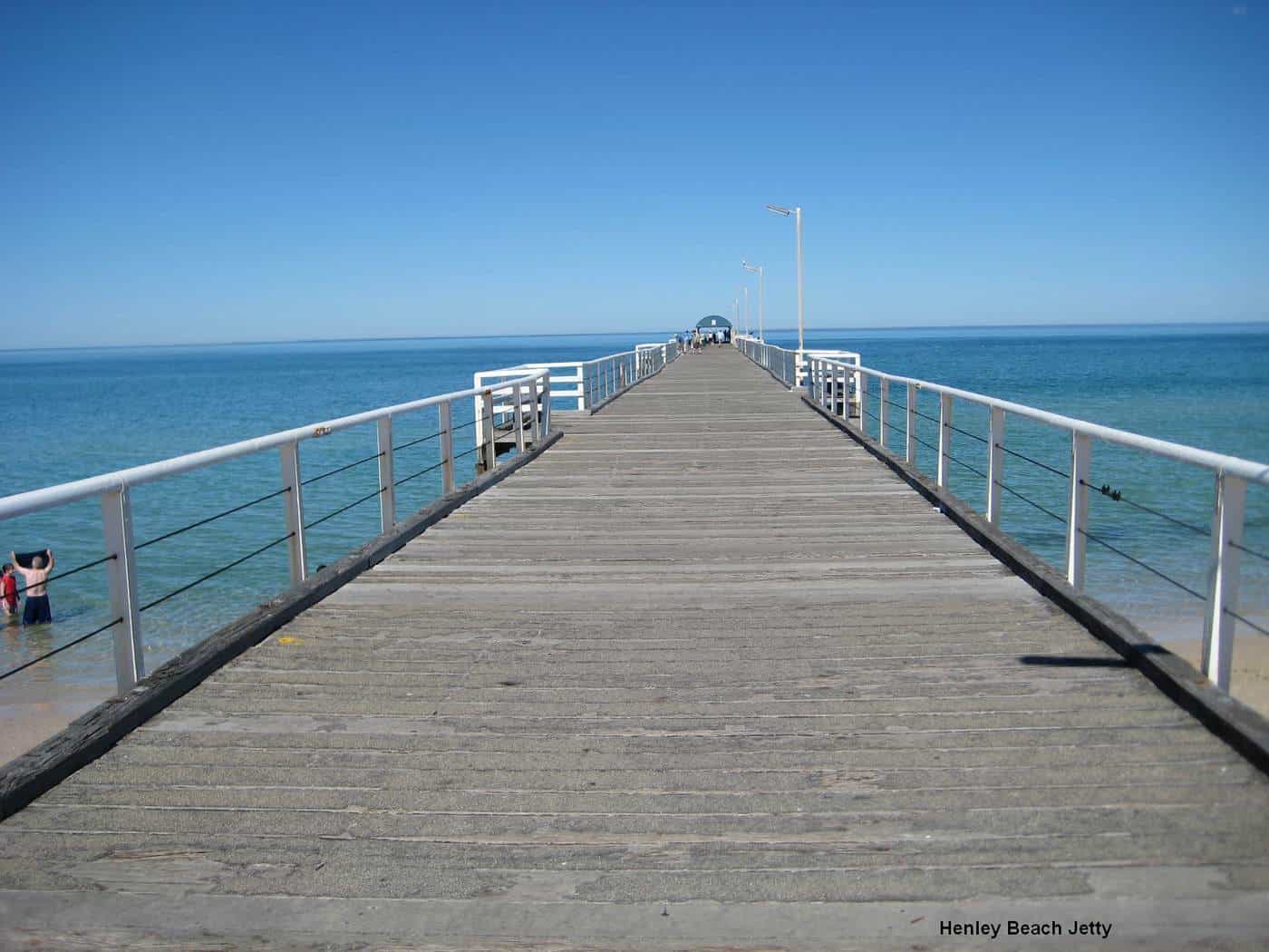 Henley Beach jetty stretching out over blue water on a sunny day